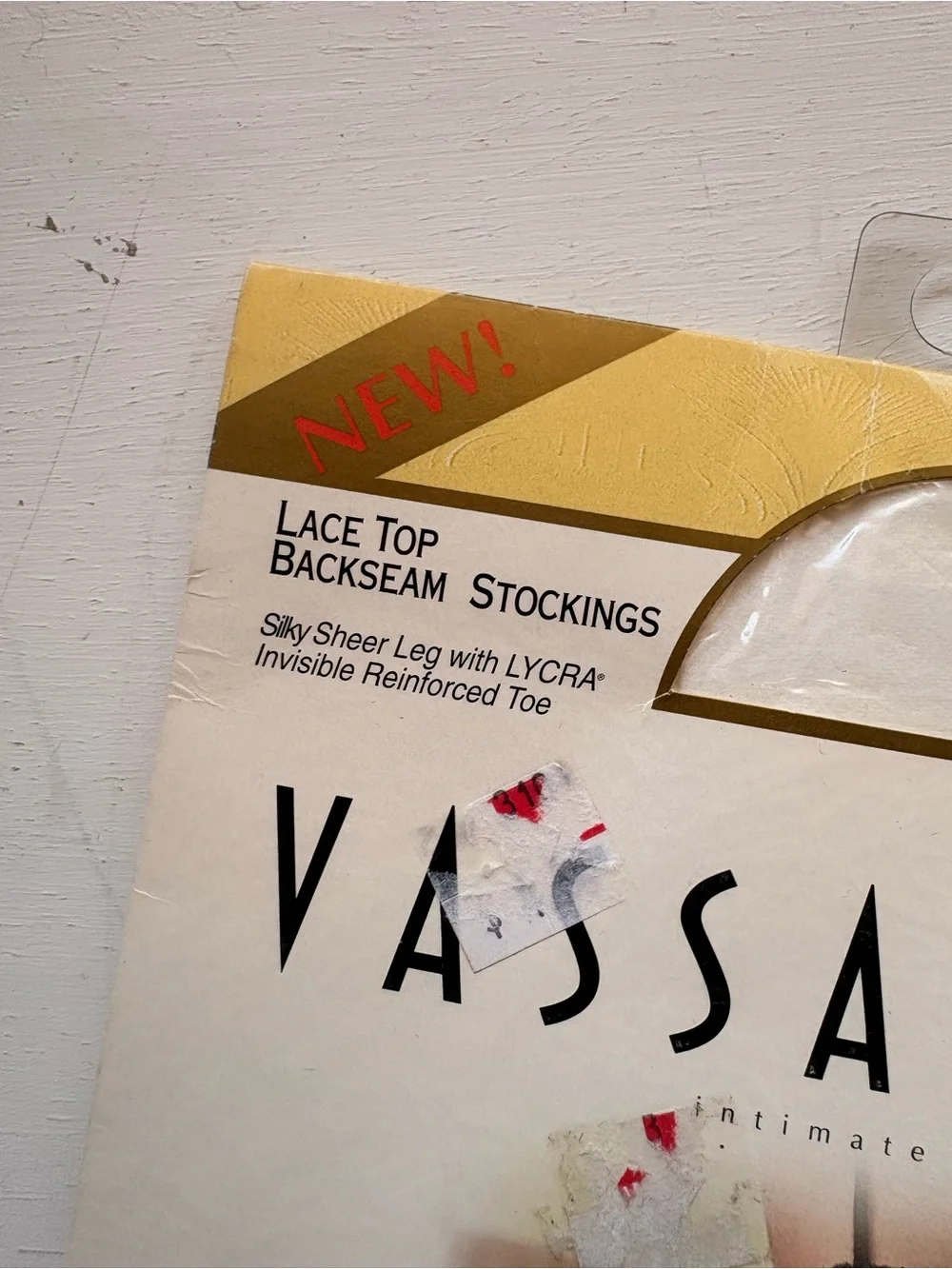 vassarette White & Gold Hosiery Packaging with Black Stocking Image